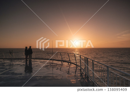 Couple enjoys serene sunset on Faroe Islands ferry deck 138095409
