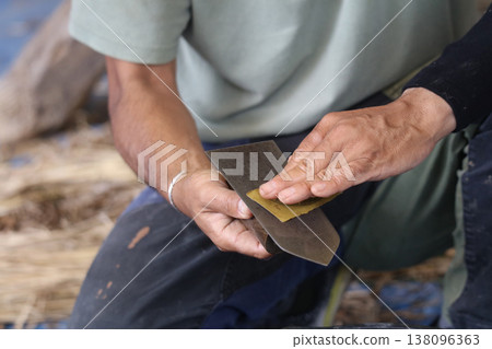 A man taking care of his plastering trowel 138096363