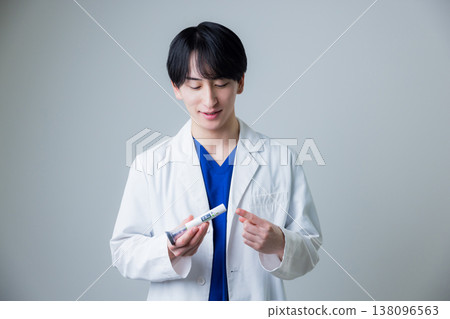 A young man wearing a white suit A young man wearing a white suit 138096563