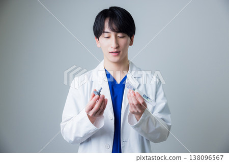 A young man wearing a white suit A young man wearing a white suit 138096567