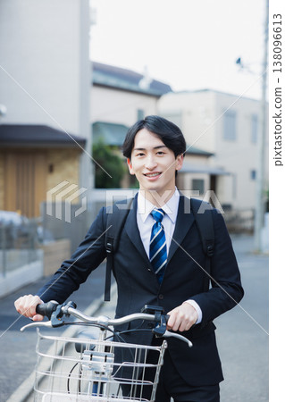 Businessman walking while pushing a bicycle 138096613