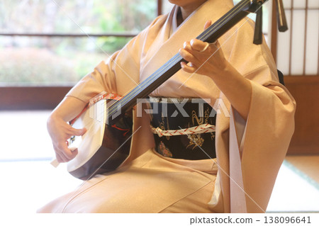 A woman playing a shamisen A woman playing a shamisen 138096641