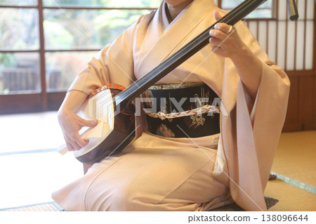 A woman playing a shamisen A woman playing a shamisen 138096644