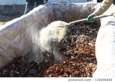 A man making a stepping hotbed A man making a stepping hotbed 138096888