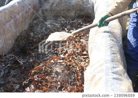 A man making a stepping hotbed A man making a stepping hotbed 138096889