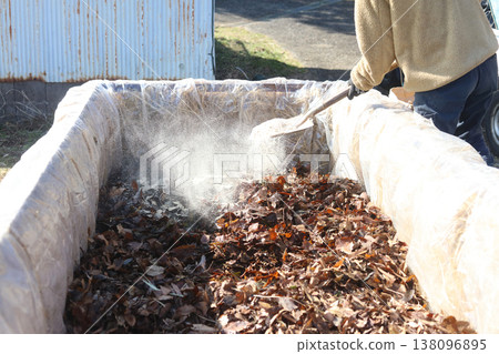 A man making a stepping hotbed A man making a stepping hotbed 138096895