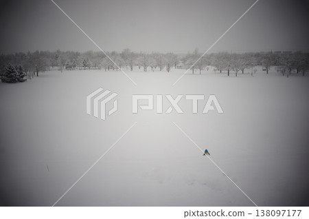 A boy playing in a park in Hokkaido in the middle of winter. A boy playing in a park in Hokkaido in the middle of winter. 138097177