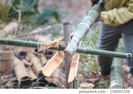 Woman splitting bamboo Woman splitting bamboo 138097288
