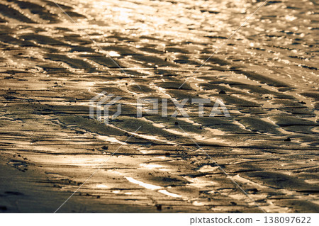 Magical sunset with orange sky and palm trees at dusk on Maldives islands, reflection on the water in beach, no people  138097622