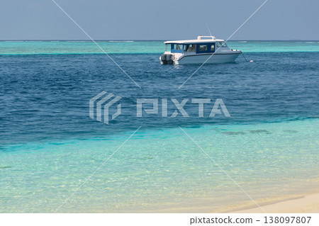 Magical seascape on Maldives islands, tourist boat, reflection on the water in beach, no people  138097807