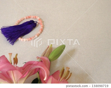 Pink lilies and prayer beads Pink lilies and prayer beads 138098719