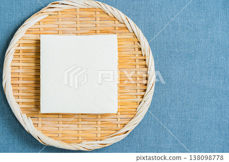 Firm tofu placed on a sieve; Japanese food ingredients on the table Firm tofu placed on a sieve; Japanese food ingredients on the table 138098778