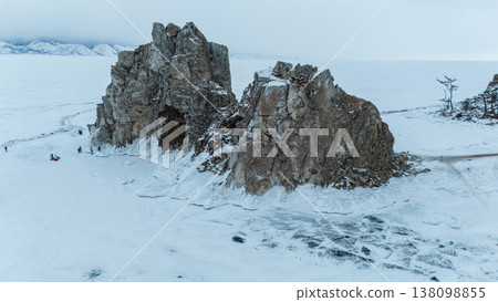 The Shaman rock at Burkhan cape covering by snow during winter season in Siberia, Russia. This rock is a subject of many popular legends and myths about Baikal Lake and Angara river. The Shaman rock at Burkhan cape covering by snow during winter season in Siberia, Russia. This rock is a subject of many popular legends and myths about Baikal Lake and Angara river. 138098855