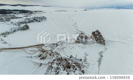 Aerial view of Shaman rock at Burkhan cape covering by snow during winter season in Siberia, Russia. This rock is a subject of many popular legends and myths about Baikal Lake and Angara river. 138098938