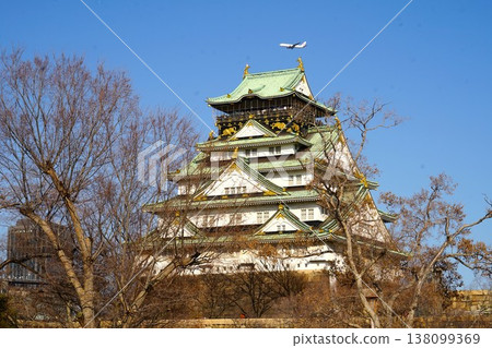Osaka Castle tower and an airplane in the background Osaka Castle tower and an airplane in the background 138099369