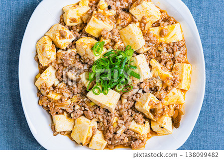 Mapo Tofu: Chinese food served on a white plate; home-style cooking at the table. 138099482