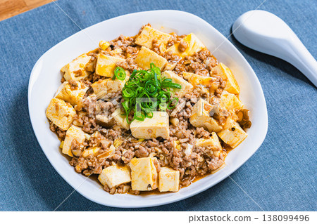 Mapo Tofu: Chinese food served on a white plate; home-style cooking at the table. 138099496