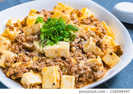 Mapo Tofu: Chinese food served on a white plate; home-style cooking at the table. Mapo Tofu: Chinese food served on a white plate; home-style cooking at the table. 138099497