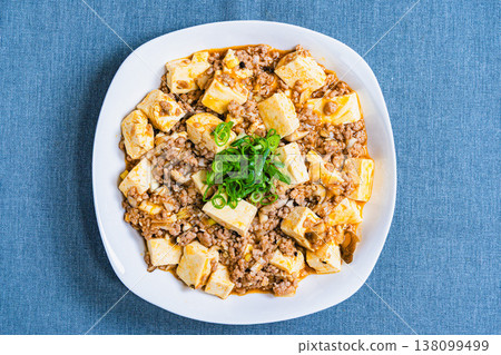 Mapo Tofu: Chinese food served on a white plate; home-style cooking at the table. 138099499
