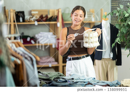 Woman choosing handbags in the store Woman choosing handbags in the store 138099931