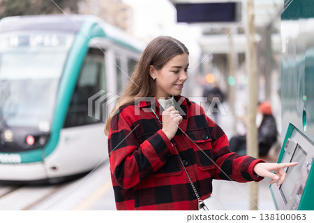 girl pays for a tram fare 138100063