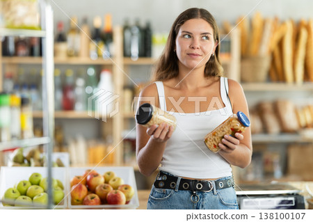 Young woman choosing beans in grocery store Young woman choosing beans in grocery store 138100107