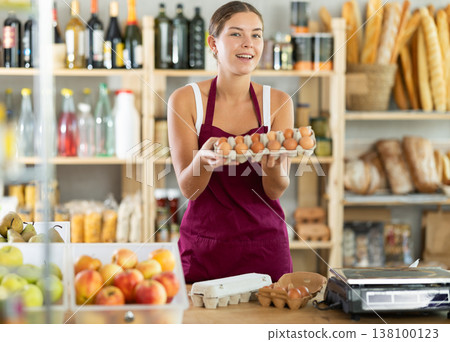 Friendly girl selling food products offers to buy chicken eggs Friendly girl selling food products offers to buy chicken eggs 138100123