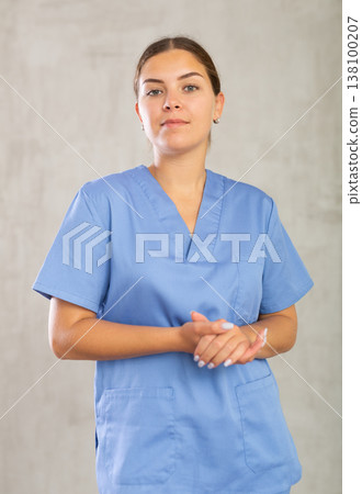 Young woman posing in medical uniform in studio 138100207