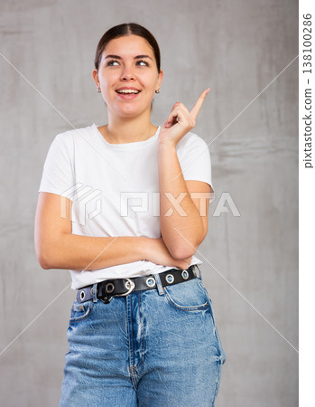 Thoughtful young woman standing in contemplative position 138100286