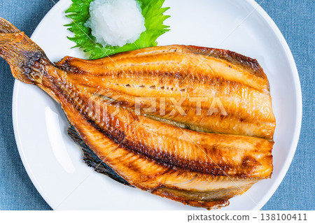 Grilled Atka mackerel with salt, served with grated daikon radish. A Japanese-style grilled fish dish. Grilled Atka mackerel with salt, served with grated daikon radish. A Japanese-style grilled fish dish. 138100411