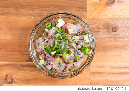 Tuna and cheese salad, seafood appetizer with plenty of condiments, Japanese food in a glass bowl Tuna and cheese salad, seafood appetizer with plenty of condiments, Japanese food in a glass bowl 138100424