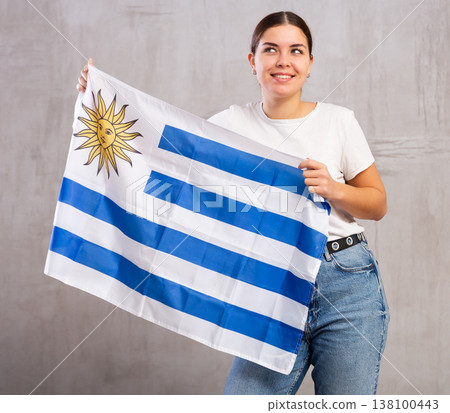 Happy girl with Uruguay flag in her hands Happy girl with Uruguay flag in her hands 138100443