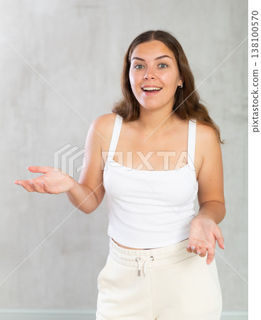 Young woman in casual clothes posing in studio 138100570