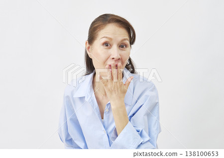 Surprised woman on white background 138100653