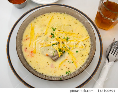 Sopa de mani is peanut soup made with beef, beef bones, potatoes and peas as main ingredients. Latin American cuisine 138100694
