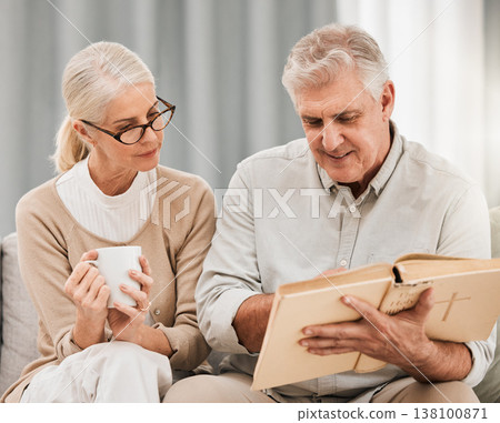 Bible, reading and senior couple in a living room with book for gospel, discussion or learning in their home. God, worship and elderly man with old woman enjoy retirement with holy, praise or faith 138100871