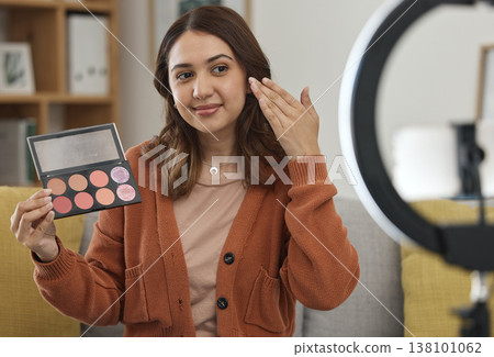 Streaming, makeup and review with a woman influencer in her home to broadcast live content to viewers. Social media, product or tutorial with a young brand ambassador in the living room for cosmetics 138101062