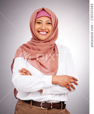 Portrait, beauty and smile with a muslim woman arms crossed in studio on a gray background. Islam, fashion or culture with a happy mature arab person looking natural or confident in her style Portrait, beauty and smile with a muslim woman arms crossed in studio on a gray background. Islam, fashion or culture with a happy mature arab person looking natural or confident in her style 138101089
