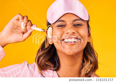Face roller, morning and portrait of woman with beauty skincare and smile isolated in studio yellow background for dermatology. Facial, detox and young person calm for care and relax with cosmetic Face roller, morning and portrait of woman with beauty skincare and smile isolated in studio yellow background for dermatology. Facial, detox and young person calm for care and relax with cosmetic 138101157