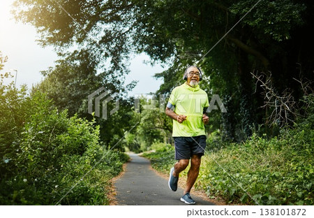 Senior man, running and listening to music on road in nature, countryside or forest for exercise in retirement. Fitness, training and workout or run on path in woods for cardio, health and wellness Senior man, running and listening to music on road in nature, countryside or forest for exercise in retirement. Fitness, training and workout or run on path in woods for cardio, health and wellness 138101872