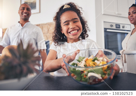 Child, smile and dinner table with salad, healthy food and thanksgiving meal with family at home. Happy, young girl and giving at a holiday with portrait and parents at lunch with people together 138102523