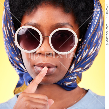 Fashion, silence and sunglasses with portrait of black woman in studio for vintage, secret and beauty. Mystery, whisper and rumor with person and scarf on yellow background for frames and style 138102526
