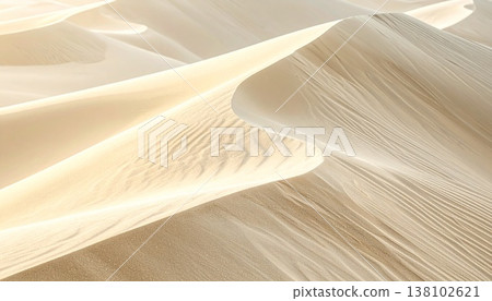A cinematic close-up of the dune ridge, highlighting its sharp edges and golden reflections of light. 138102621