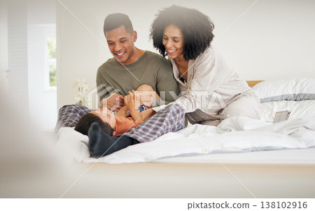 Happy, family tickle and bedroom with laughing with bonding of father, mother and child smile. Home, mom and dad together with love, bonding and care in bed in morning with kid in house with parents Happy, family tickle and bedroom with laughing with bonding of father, mother and child smile. Home, mom and dad together with love, bonding and care in bed in morning with kid in house with parents 138102916