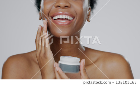 Black Woman, face cream and skincare with beauty, facial and cosmetic product in container, studio background and smile. Happy, female and healthy skin with moisturizer, cosmetology and dermatology Black Woman, face cream and skincare with beauty, facial and cosmetic product in container, studio background and smile. Happy, female and healthy skin with moisturizer, cosmetology and dermatology 138103165