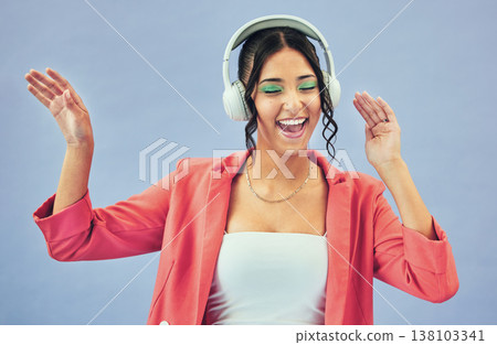 Dance, smile and woman with headphones, celebration and makeup on a blue studio background. Person, girl and model with headset, energy and streaming music with happiness, audio and song with sound Dance, smile and woman with headphones, celebration and makeup on a blue studio background. Person, girl and model with headset, energy and streaming music with happiness, audio and song with sound 138103341