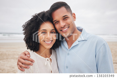 Couple, hug and portrait by ocean, smile and love in marriage, getaway and holiday for bonding. Mexican people, happy and relax at beach or sea, vacation and travel or trip, summer and peace by waves 138103349