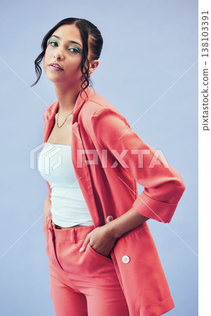 Fashion, portrait and girl in suit in studio with makeup, confidence and pride in cool color. Beauty, style and influencer woman in designer clothes, trendy promo or model standing on blue background 138103391
