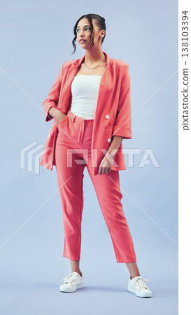 Fashion, thinking and body, woman in studio with makeup, confidence and luxury color suit. Beauty, style and influencer girl in designer clothes, trendy promo and model standing on blue background. 138103394