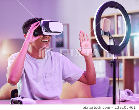 VR, live streaming and man gamer with future on social media for digital connection in metaverse vlog in a home. Ring light, streamer and content creator or person speaking on internet show as host VR, live streaming and man gamer with future on social media for digital connection in metaverse vlog in a home. Ring light, streamer and content creator or person speaking on internet show as host 138103461